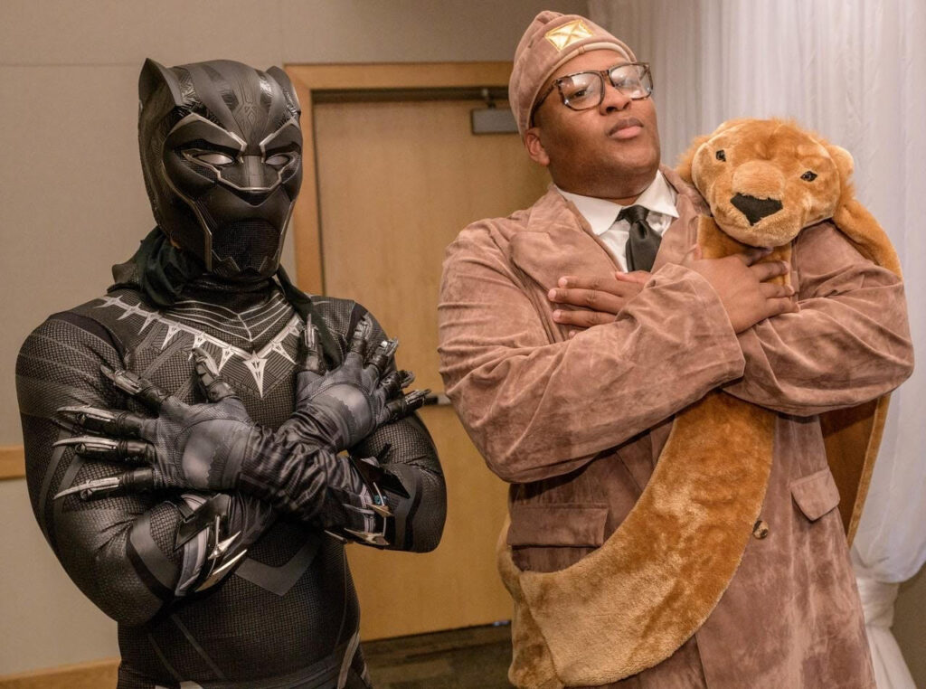 Cosplayers dressed as characters from Black Panther and Coming to America